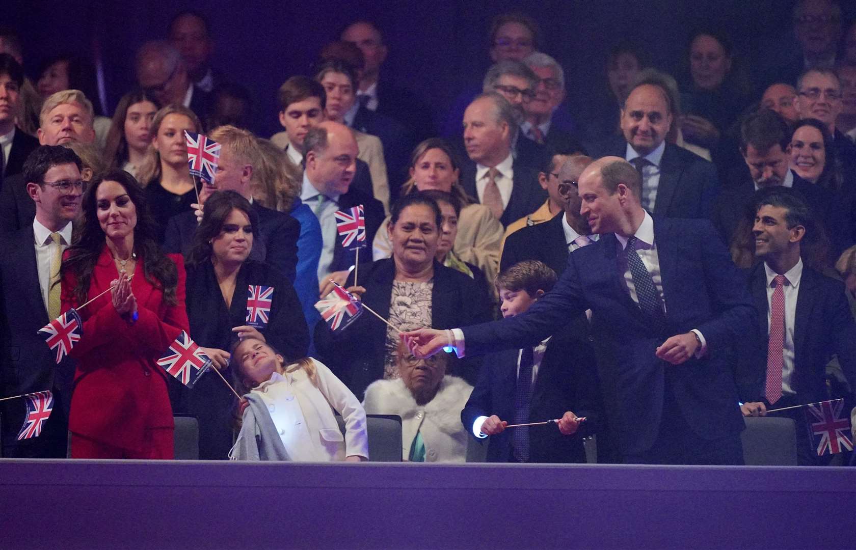 William waves a flag at his daughter Charlotte (Yui Mok/PA)