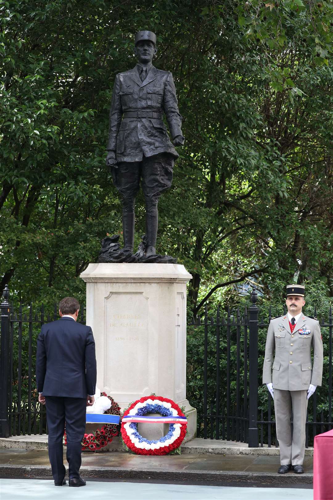 Emmanuel Macron lays a wreath at the foot of the statue of Charles de Gaulle (Jonathan Brady/PA)