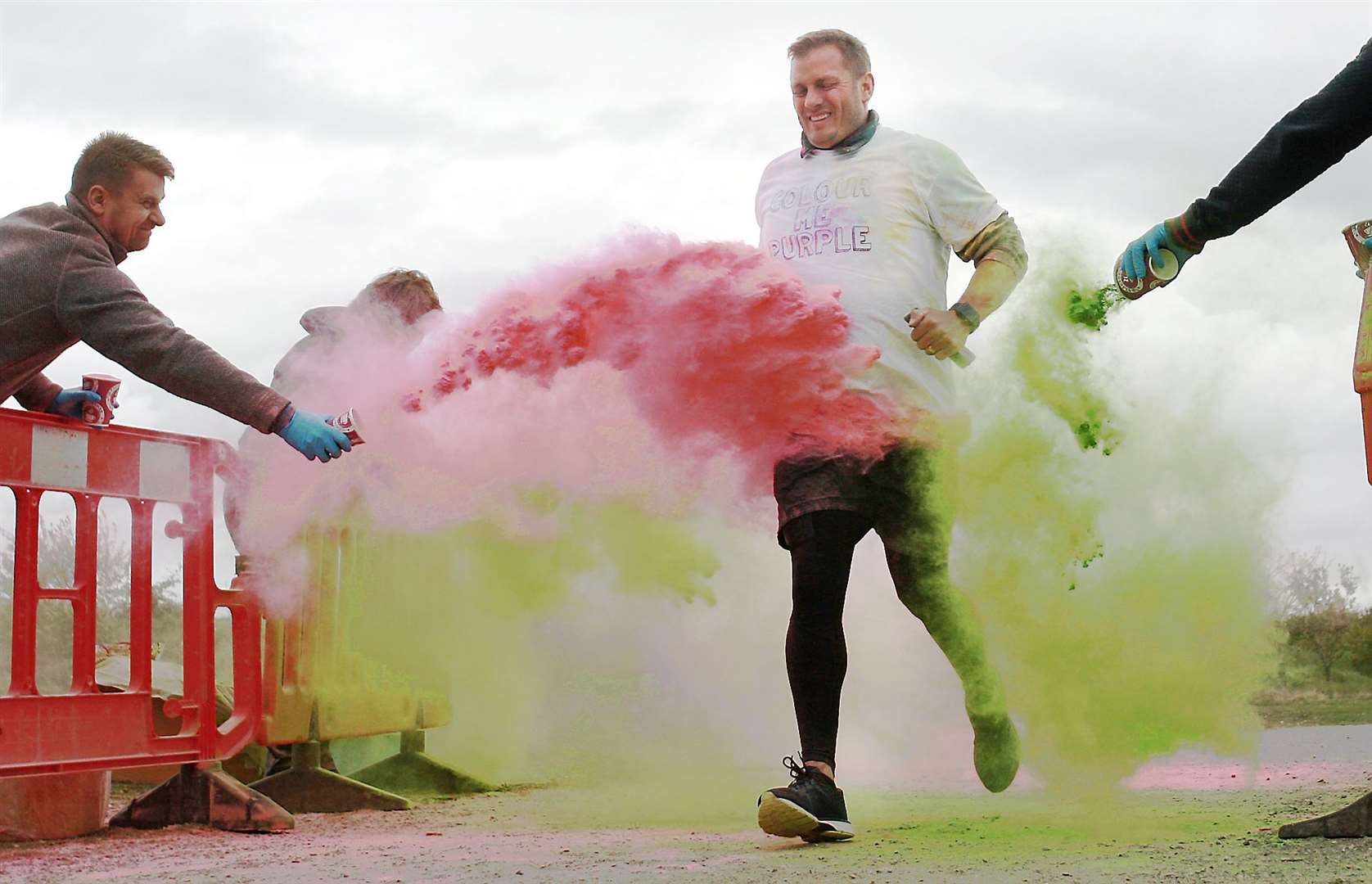 Competitors are pelted with coloured dye during the Colour Me Purple 5km run through Milton Creek Country Park for the Wisdom Hospice. Picture: Phil Lee