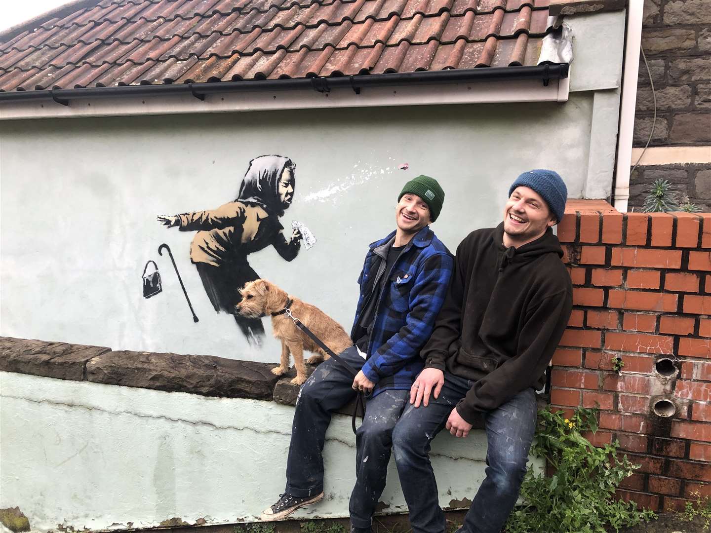 Fred Loosmore, right, and his colleague Sam Hunt attached a large piece of acrylic over the artwork to protect it (Claire Hayhurst/PA)