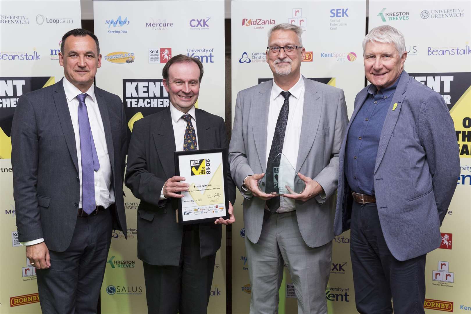 The overall area winners. from left, Steven Holdcroft University of Kent, Cllr Roger Gough KCC, Steve Davies Sheerness West Federation Overall Kent Executive Head Teacher of the Year, Teachers from across Kent attend the Teacher Of The Year awards at The Great Danes Hotel, Maidstone. Picture Submitted by: Martin AppsKM Group has permission to sell this image via photo sales and to re-sell the image to other media for single-use publication. (2088735)