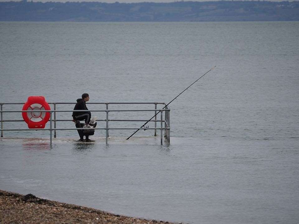 High tide fisherman at Neptune Jetty, Sheerness. Picture copyright James Bell