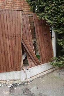 A fence damaged in a wrecking spree by a mystery Land Rover