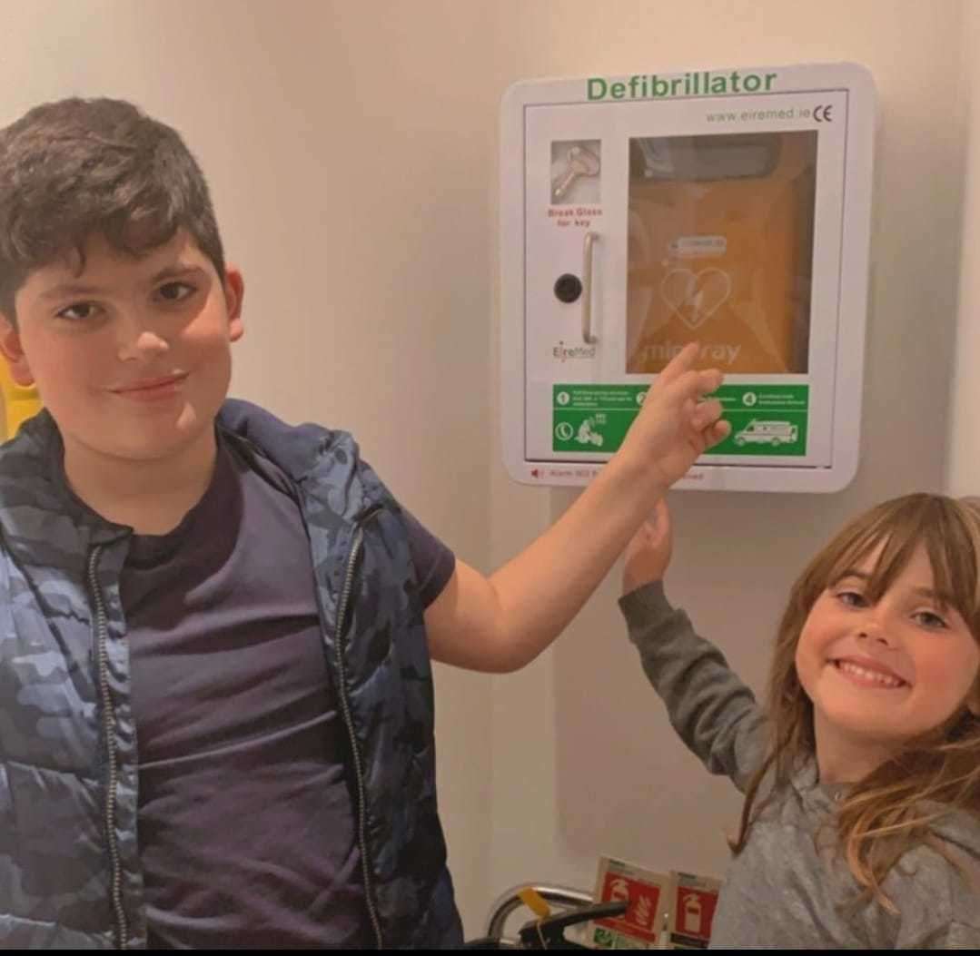 Archie and sister Amelia with a recently installed defibrillator