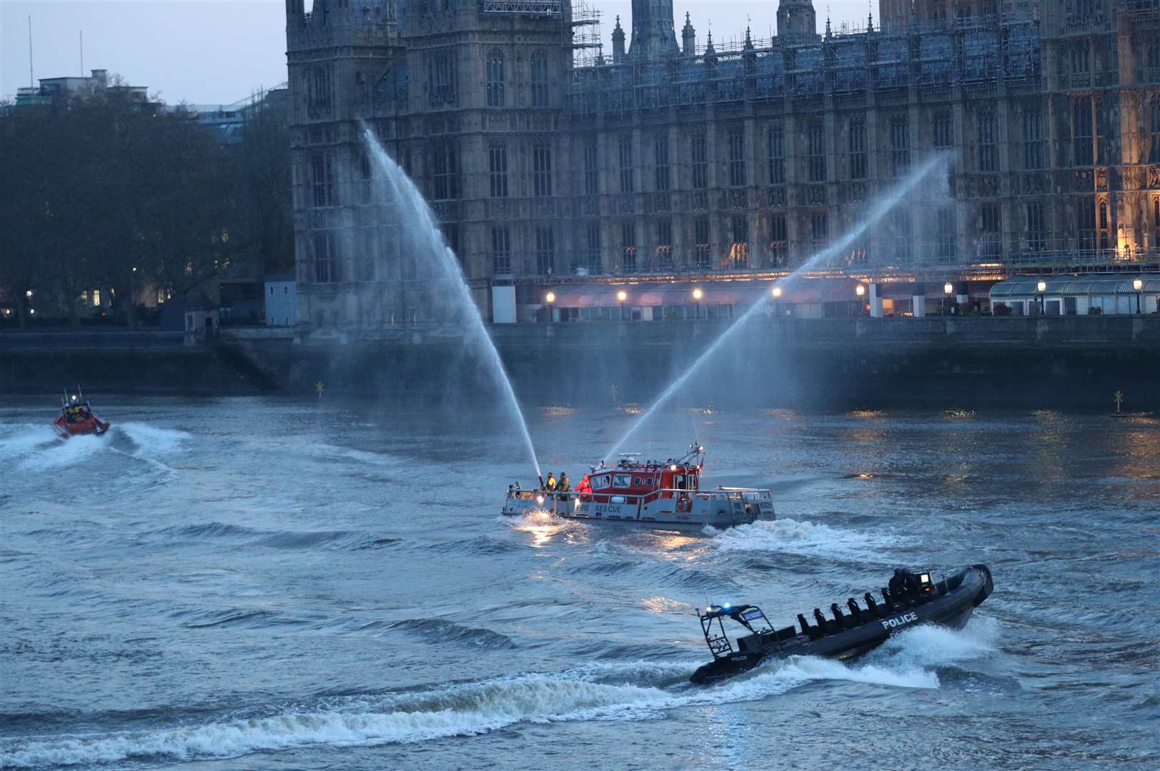 Boats sprayed jets of water on the Thames during the round of applause (Yui Mok/PA)