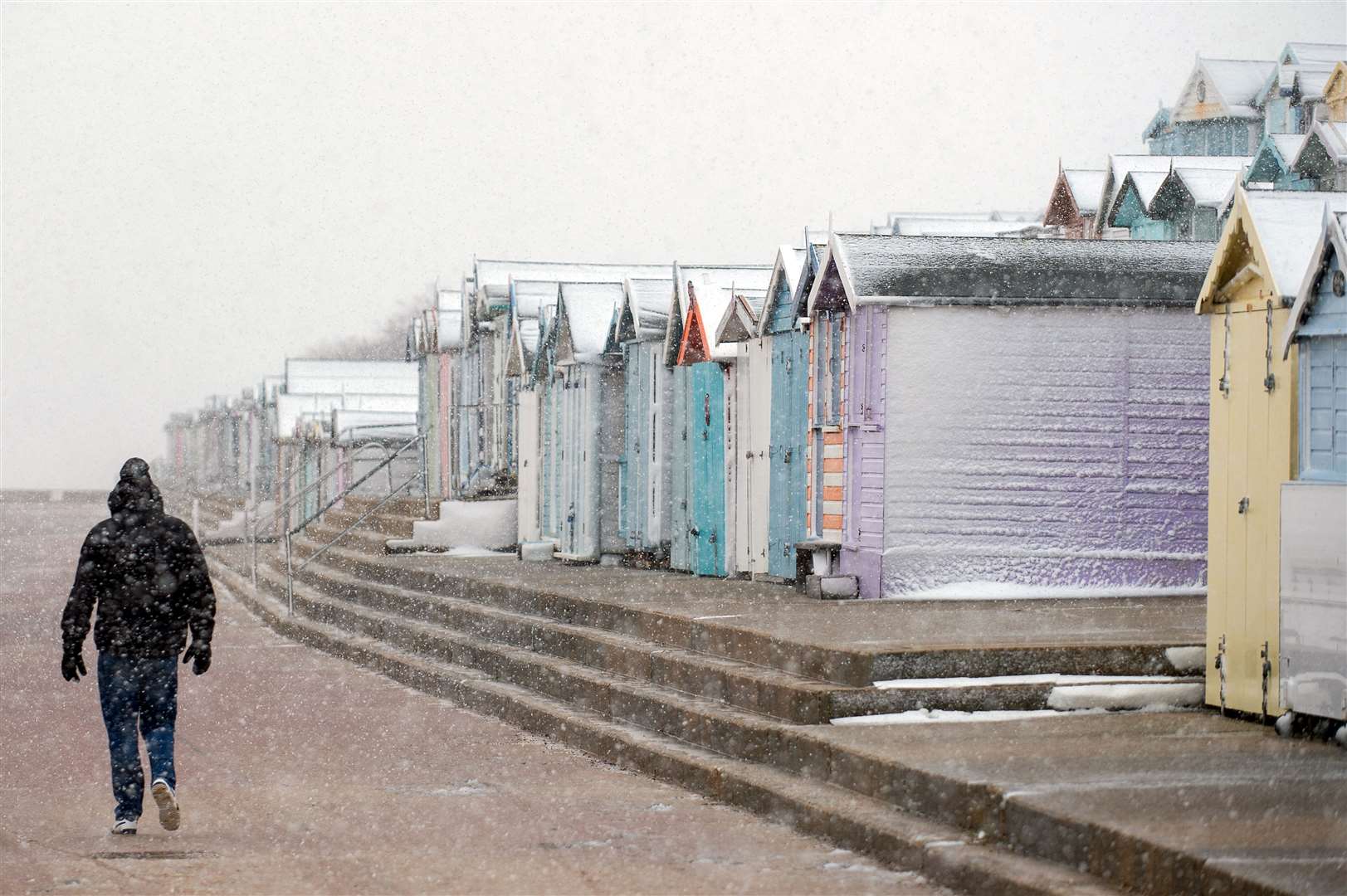 Snow-covered beach huts at Walton-on-the-Naze in Essex (Joe Giddens/PA)