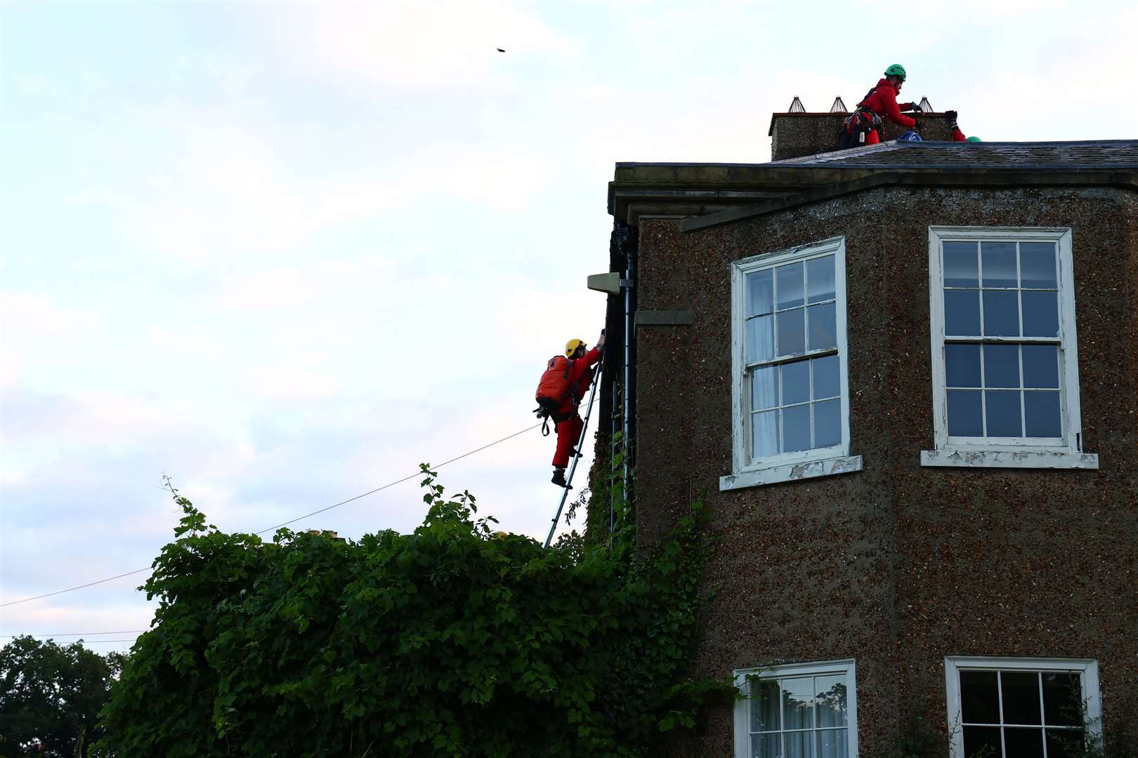 Greenpeace activists covering the house in black fabric (Luca Marino/Greenpeace/PA)