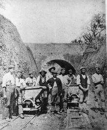 Rainham chalk pit workers in front of the tunnel which took the narrow guage railway from the chalk pit to the cement works and Rainham Dock