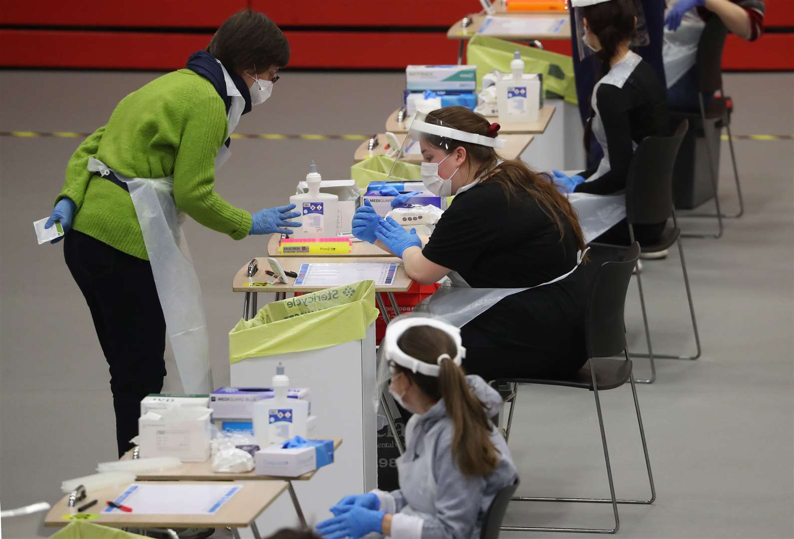 People carry out asymptomatic testing using lateral flow antigen at a centre at Edinburgh University (PA)