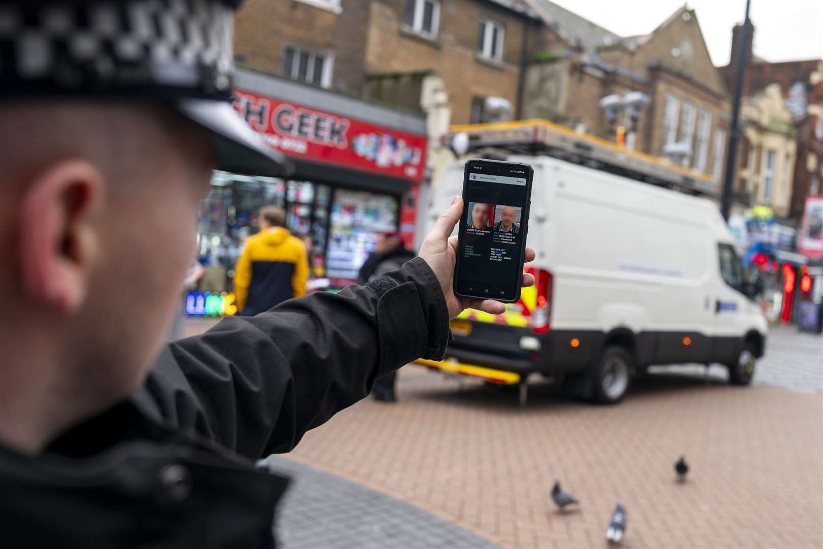 A police officer demonstrates the smart phone app used by the Met’s live facial recognition technology in Croydon (Jordan Pettitt/PA)