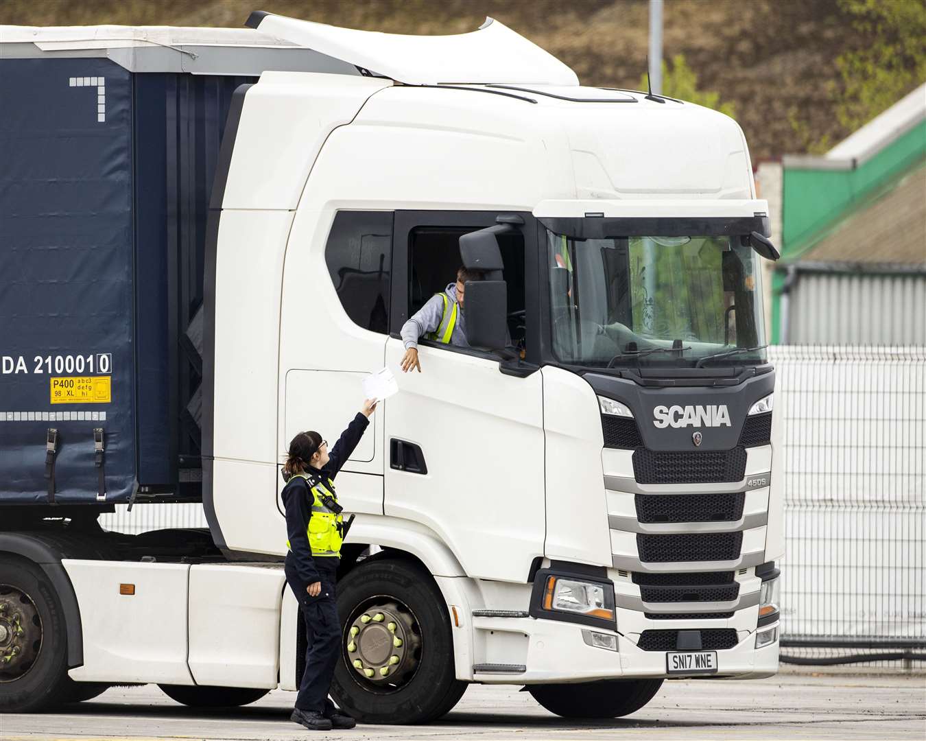 A Border Force officer returns papers to a haulage driver after protocol checks at Belfast Port (Liam McBurney/PA)