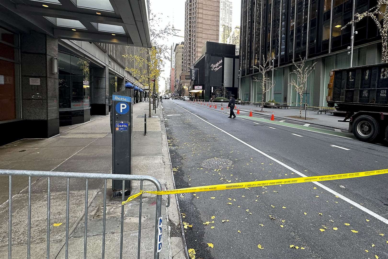 A New York police officer walks outside a hotel in midtown Manhattan where Brian Thompson, the chief executive of UnitedHealthcare, was fatally shot (Joe Frederick/AP)