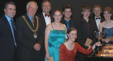 Katherine Tinker with her trophy and other competitors and VIPs