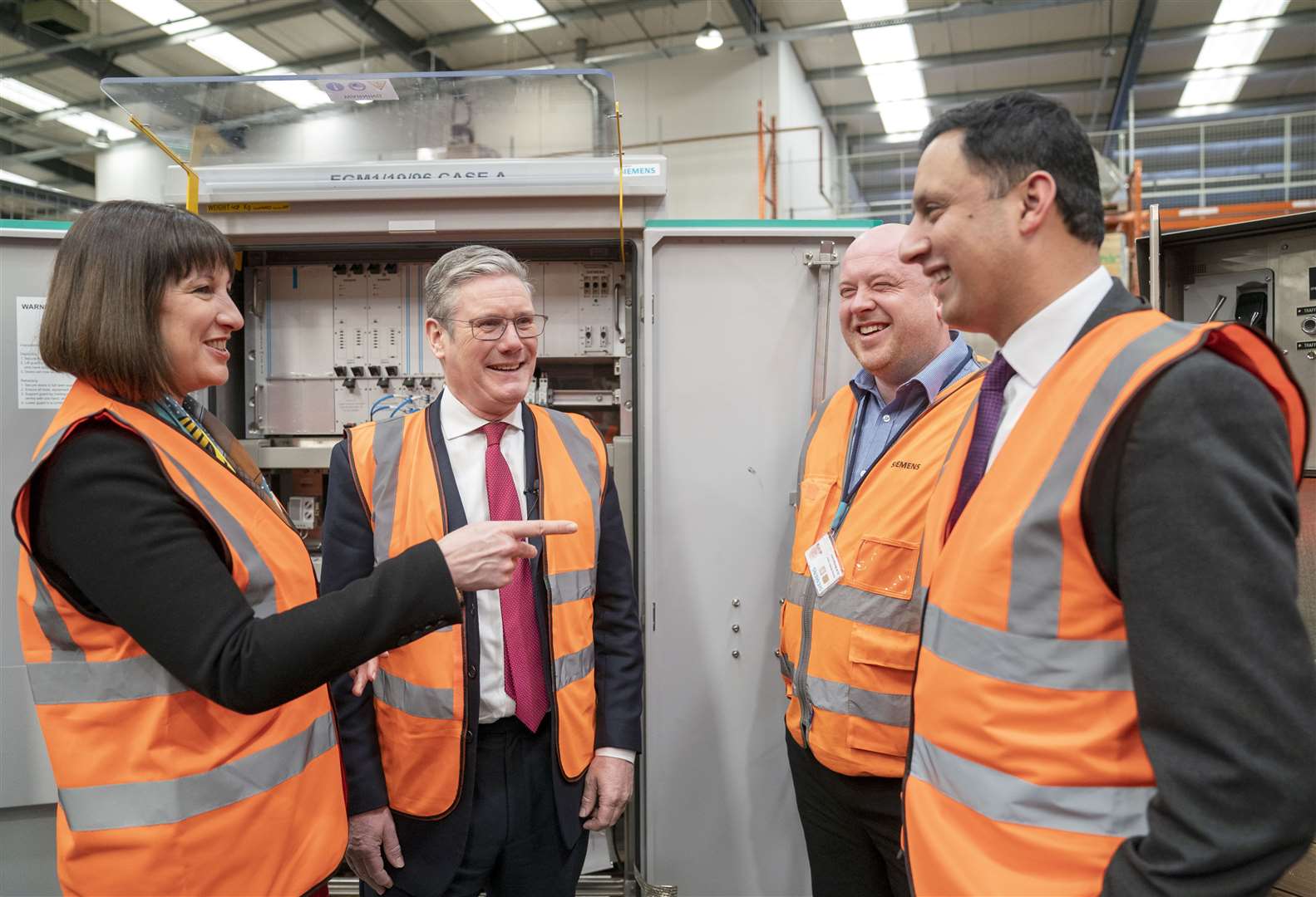 Sir Keir Starmer, Rachel Reeves and Anas Sarwar meet lead design manager Scott Montgomery at Siemens Rail Automation Cambuslang depot (Jane Barlow/PA)