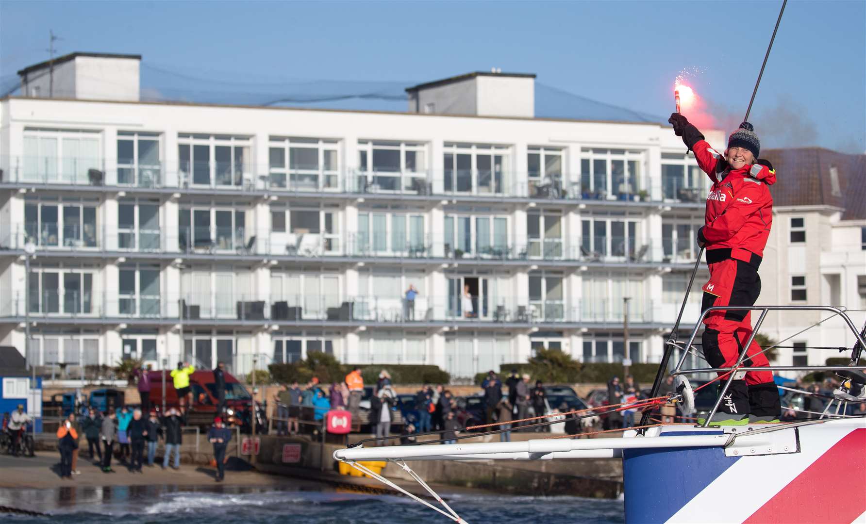 Pip Hare sets off a flare as she sails her boat Medallia into Poole (Andrew Matthews/PA)