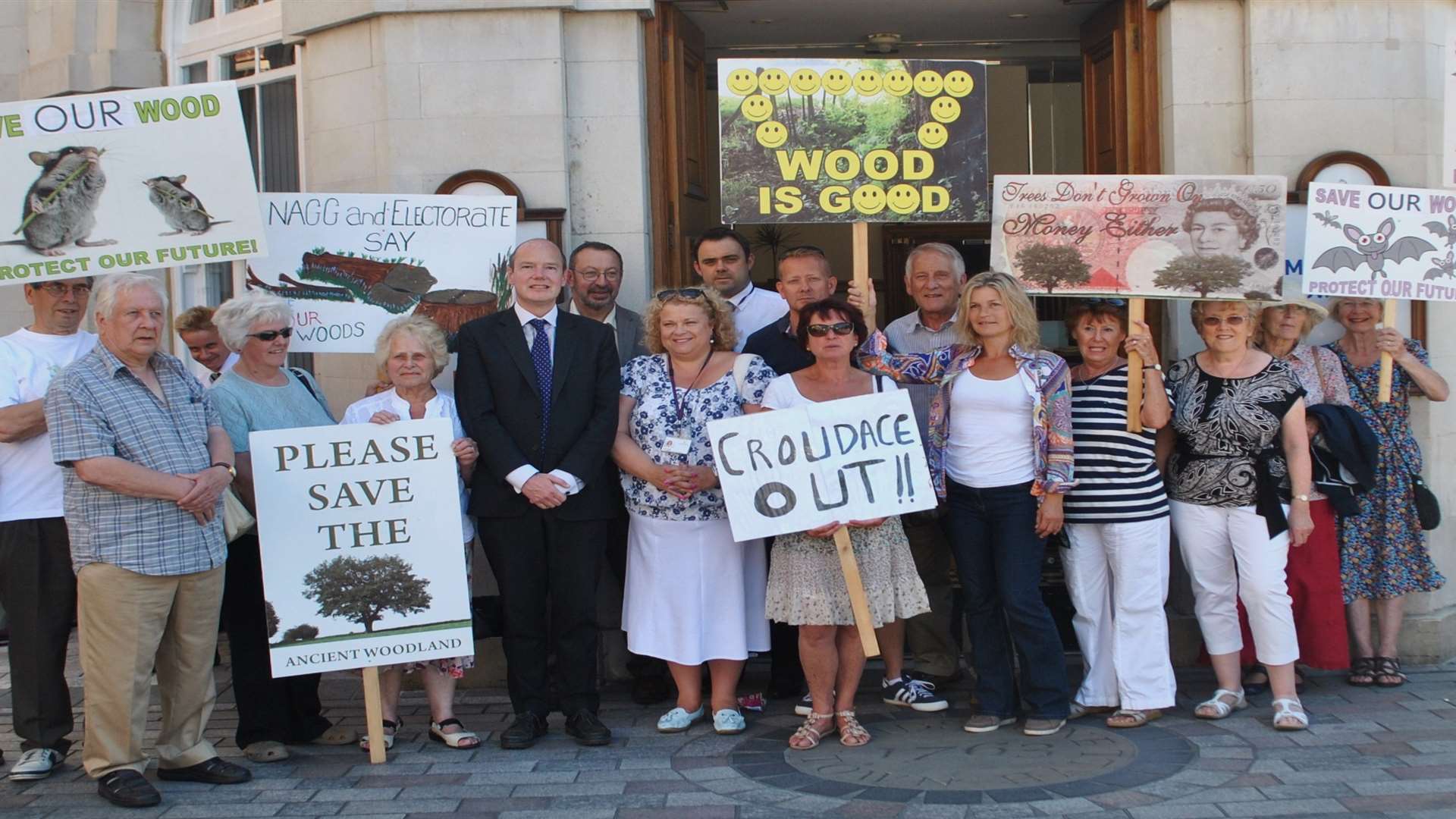 Protestors make their feelings known before the meeting