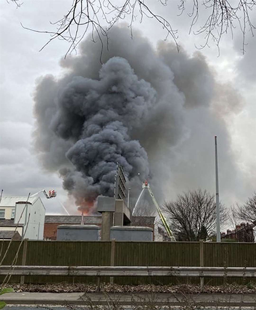 Smoke rises from a fire at a three-storey warehouse in Holland Street, Denton (Louise Caine/PA)