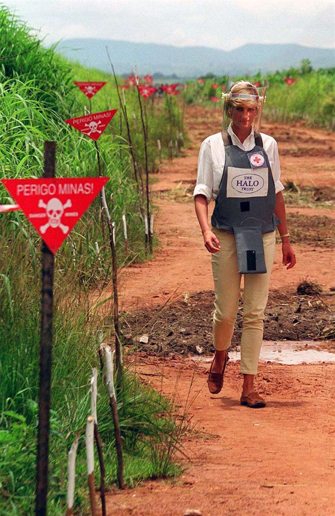 In 1997, Diana toured a minefield in Angola in body armour to learn about the carnage military munitions can cause (John Stillwell/PA)