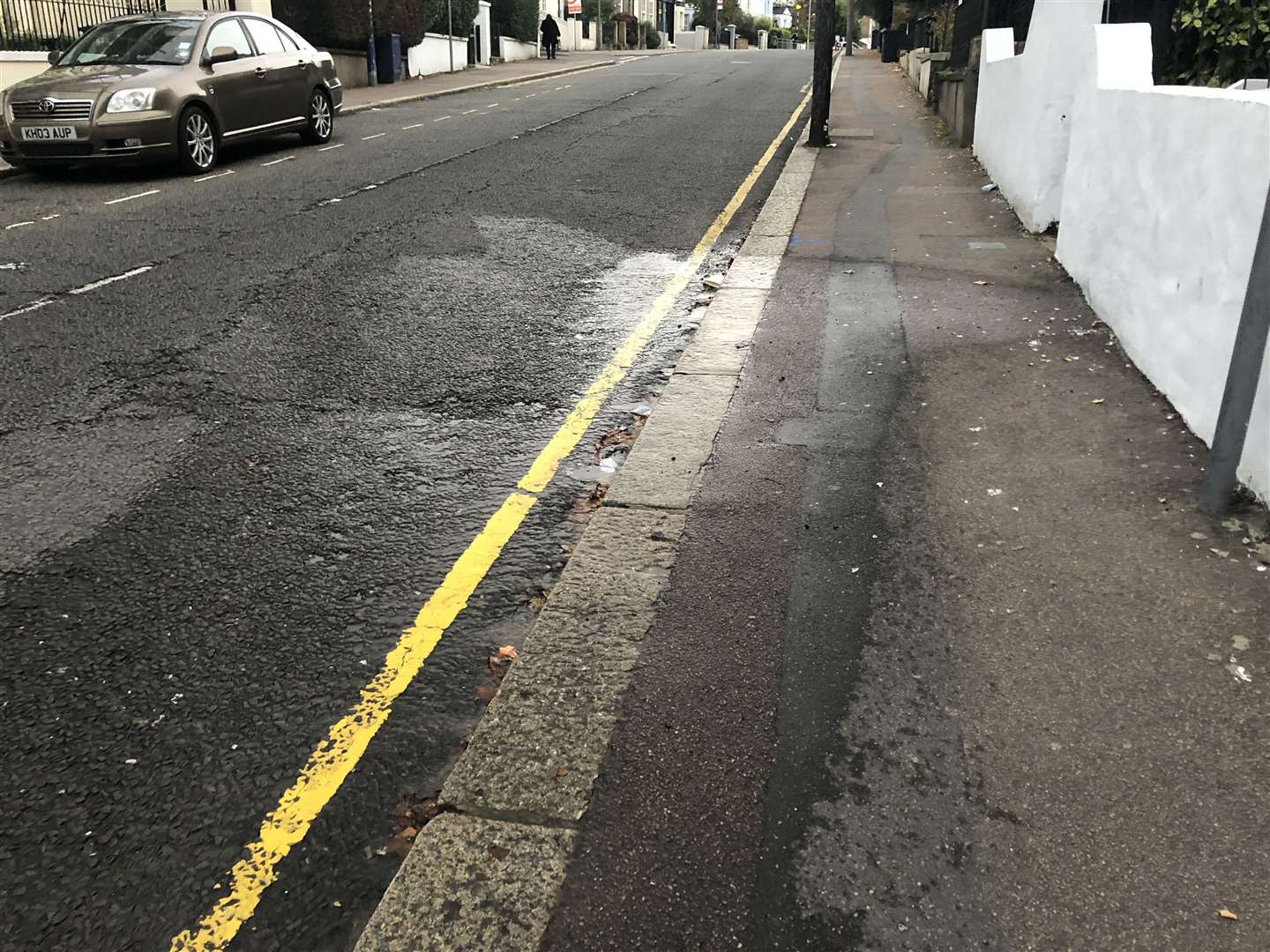 The water is running down the side of the kerb