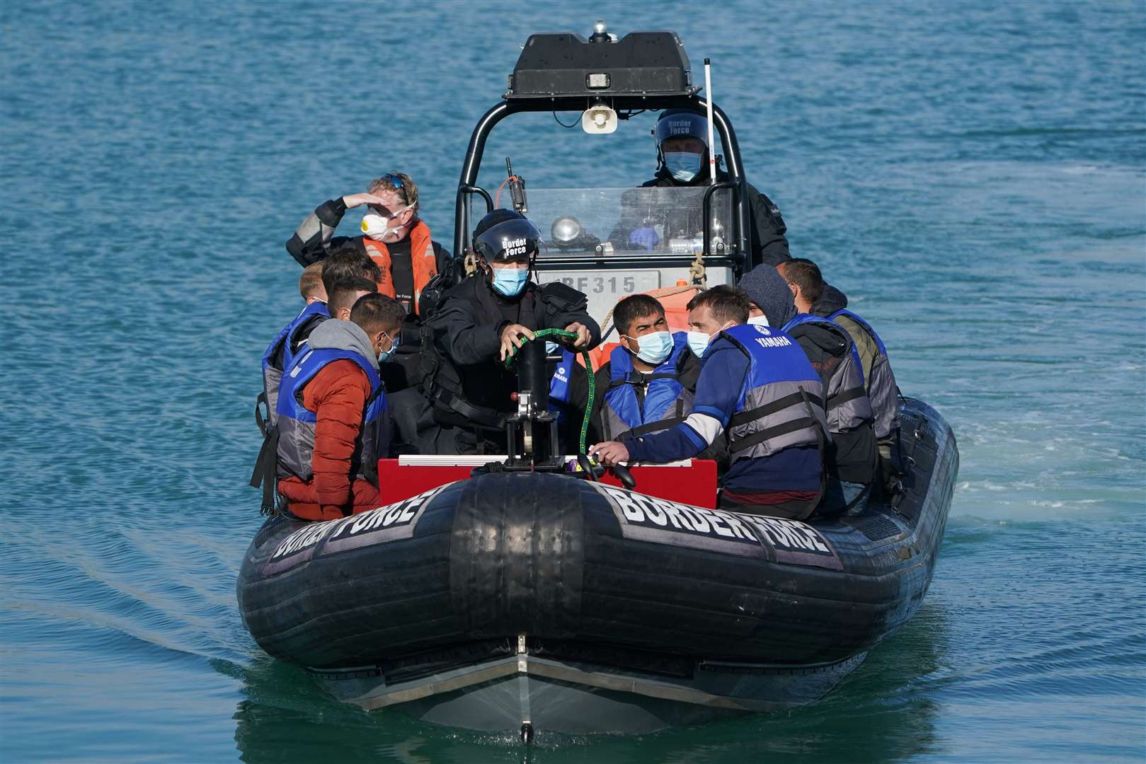 A group of people thought to be migrants are brought into Dover, Kent, following a small boat incident in the Channel (Gareth Fuller/PA)