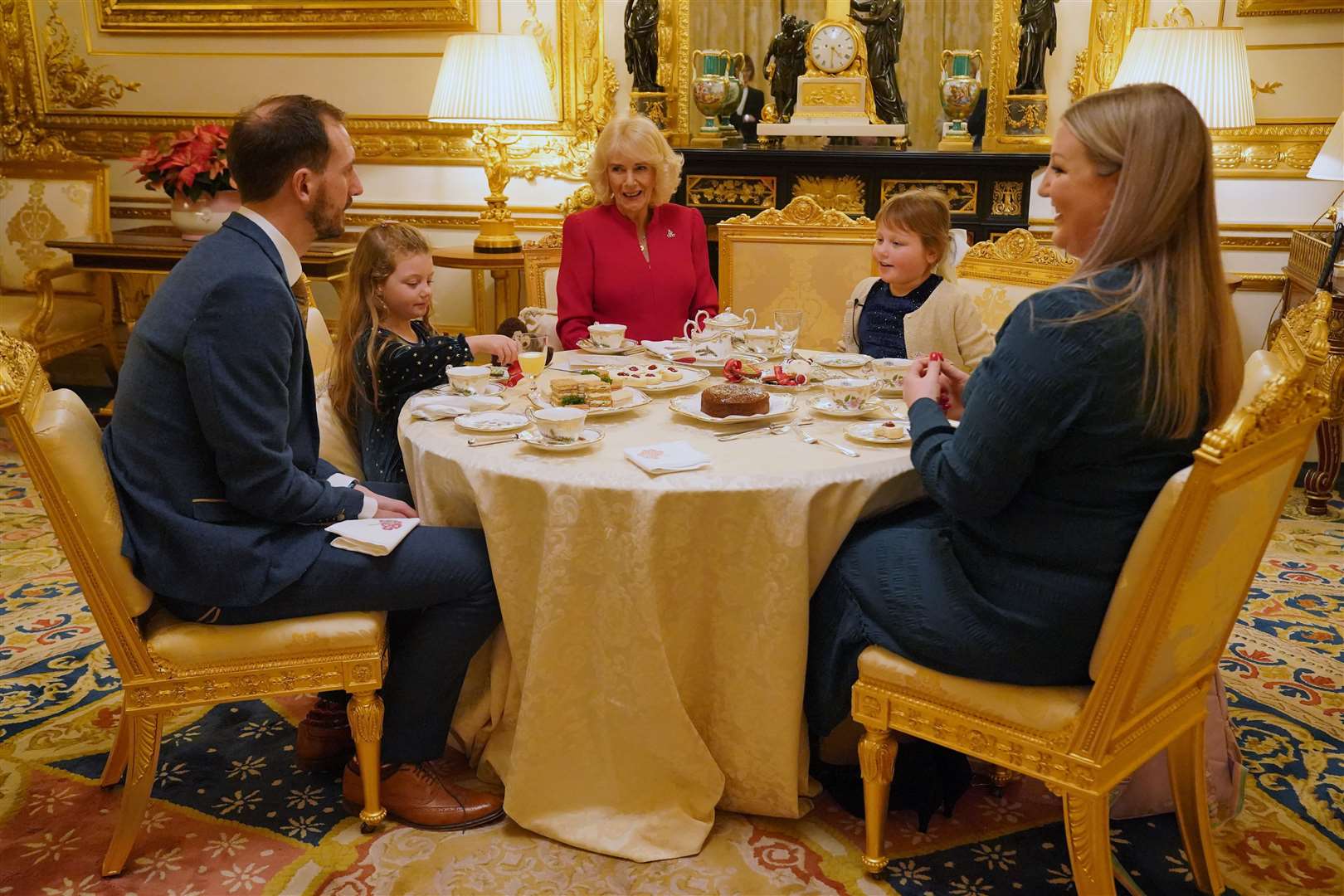 Olivia with her sister Imogen, four, (second left), father Matt (left), and mother Lisa (right) at Windsor Castle (Jonathan Brady/PA)
