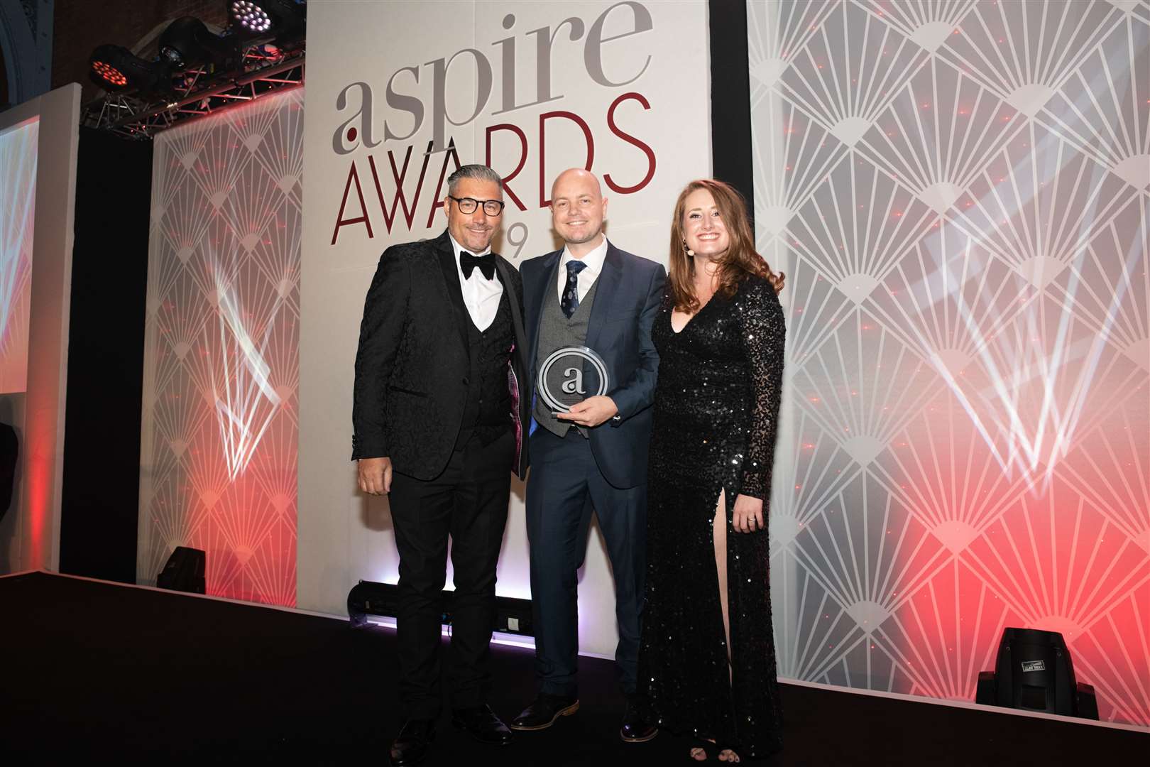 Jamie Revell, centre, picks up his Aspire Award in London