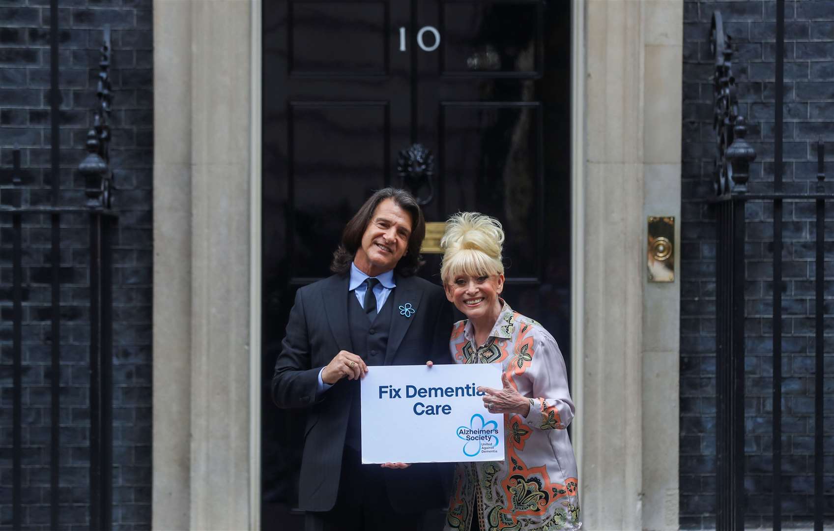 Dame Barbara Windsor and her husband Scott Mitchell deliver an Alzheimer’s Society open letter to 10 Downing Street (Simon Dawson/PA)