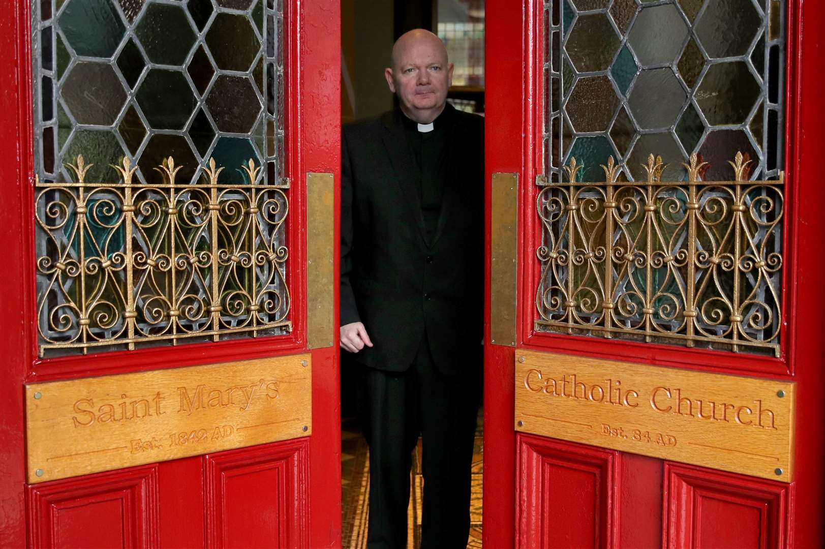 Canon Tom White opens the doors to worshippers at St Mary’s church in Calton, Glasgow (Andrew Milligan/PA)