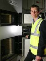 Cllr Mark Wooding (Con) inspects the council's biomass burner, which will burn local wood. Picture: Roger Adley