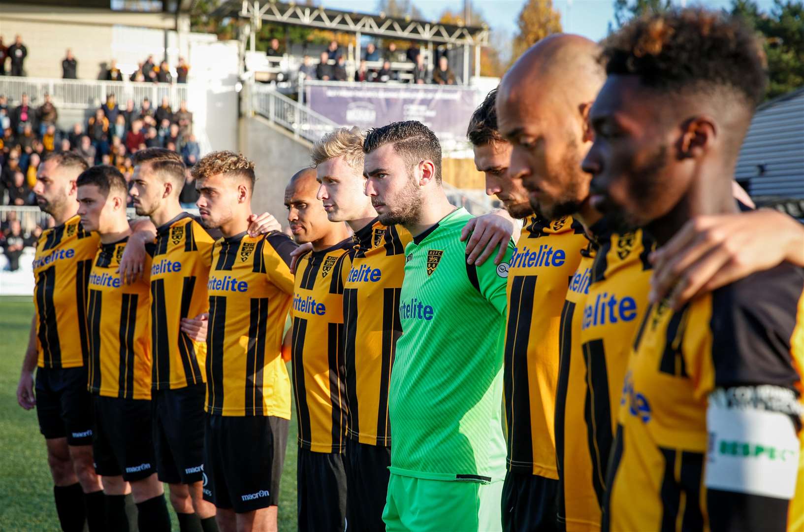 The players pay their respects during a minute's silence to commemorate the end of the First World War Picture: Matthew Walker