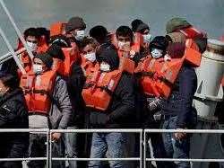 People arriving in the UK after crossing the Channel in small boats. Stock picture