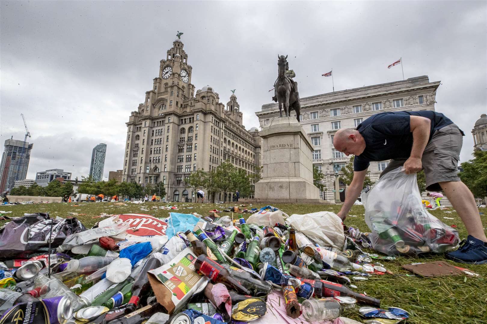 Work begins to clear up rubbish left outside the Liver Building (Peter Byrne/PA)