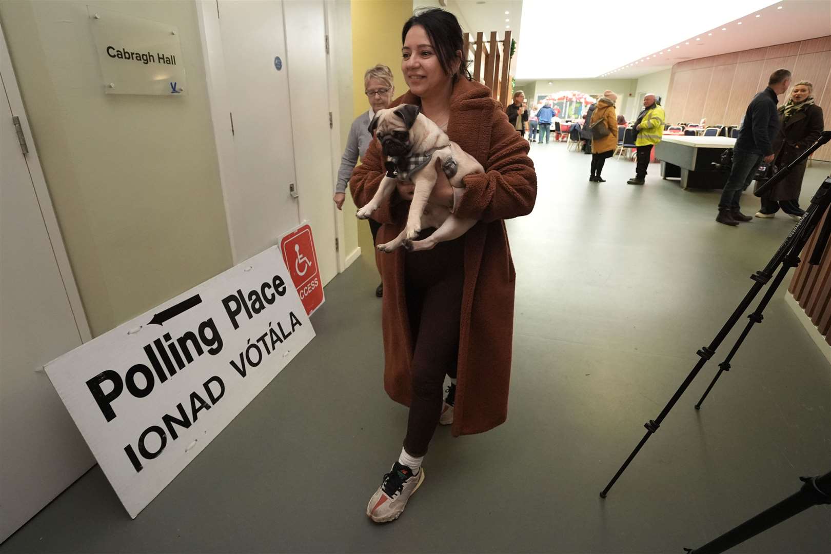 Sonia Higgins, with her pet pug named Chico, arrives to cast her vote at Deaf Village Ireland (DVI) on Navan Road, Dublin (Brian Lawless/PA)