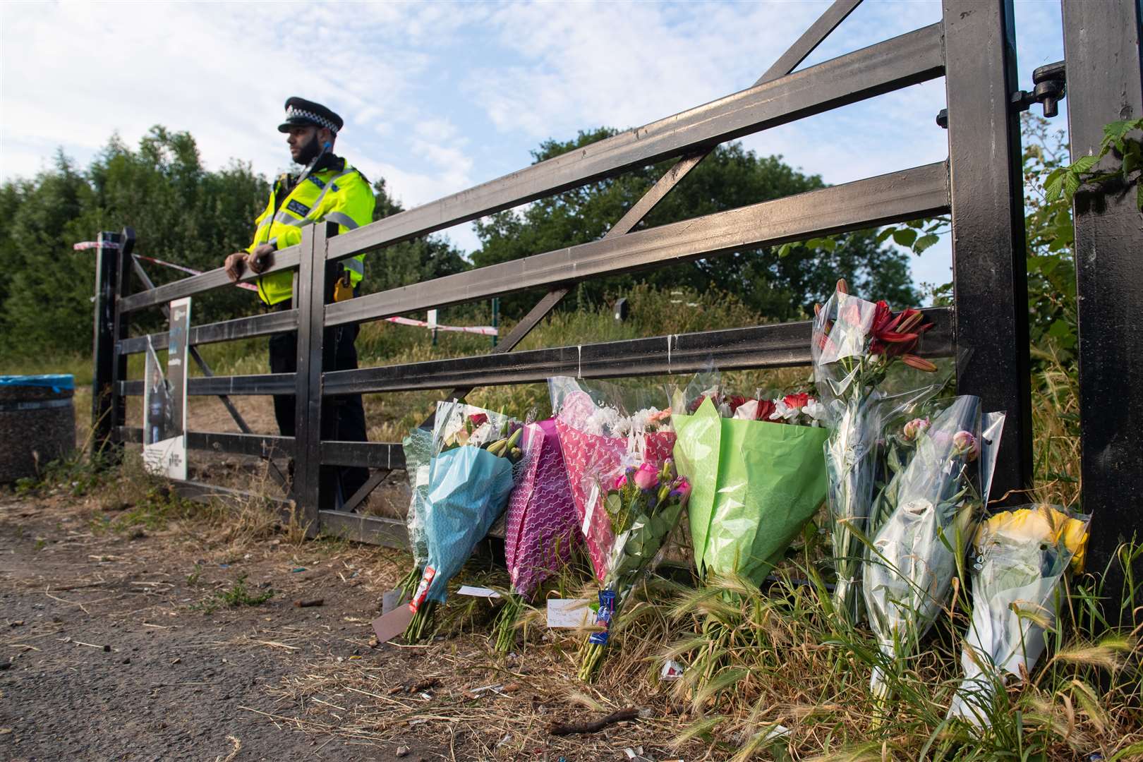 Flowers at an entrance to Fryent Country Park, in Wembley, north-west London, where Nicole Smallman and Bibaa Henry were killed (Dominic Lipinski/PA)