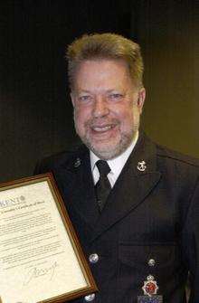 Former Kent Police officer Roland Barber receiving a certificate of merit award
