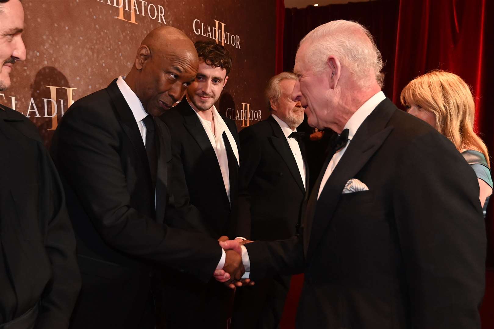 The King meets Denzel Washington and Paul Mescal whilst attending the Royal film performance and world premiere of Gladiator II (Eddie Mulholland/The Telegraph/PA)