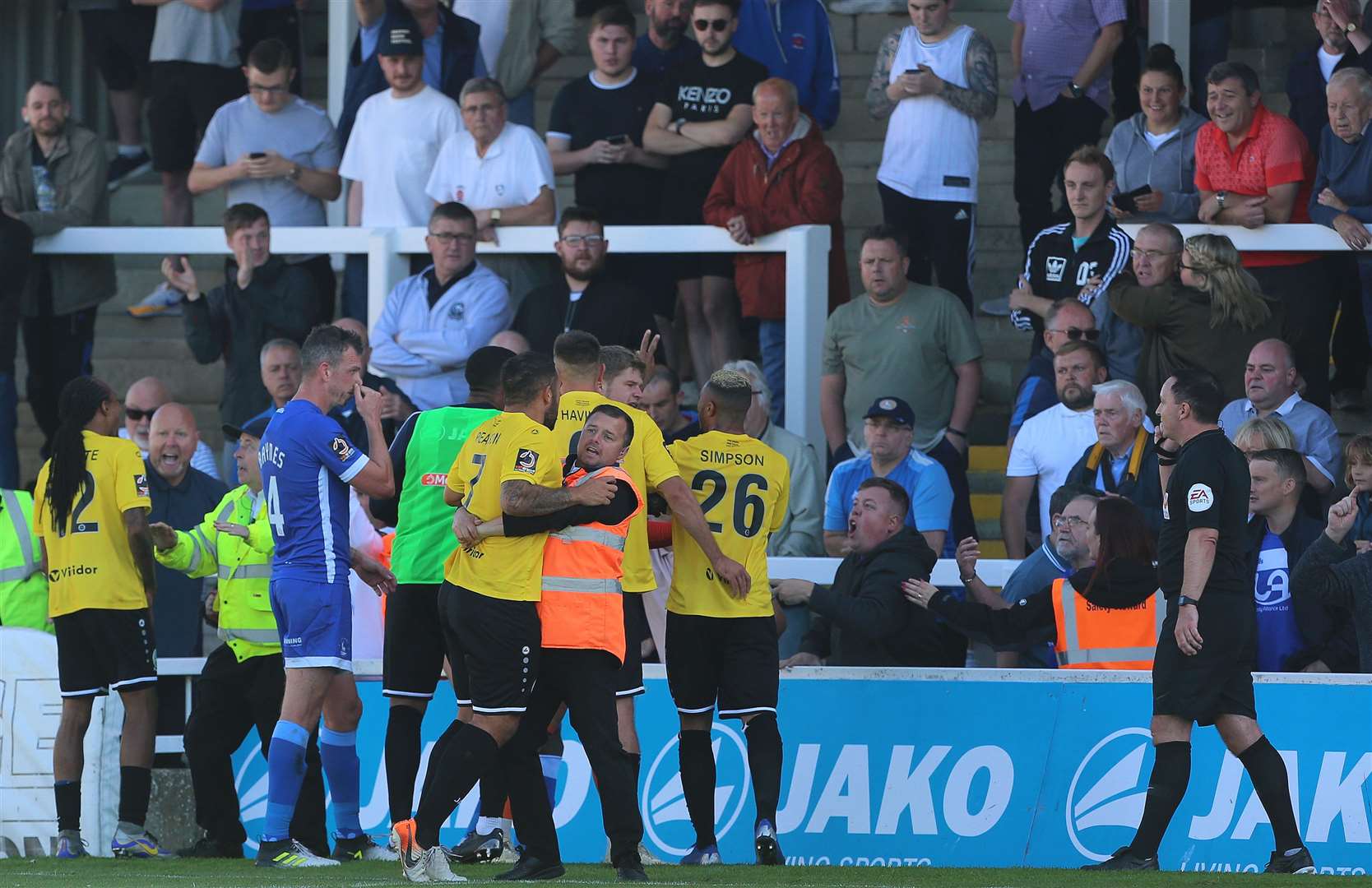 Jai Reason is restrained by a steward after Dover's players were racially abused at Hartlepool on Saturday. Picture: Mark Fletcher