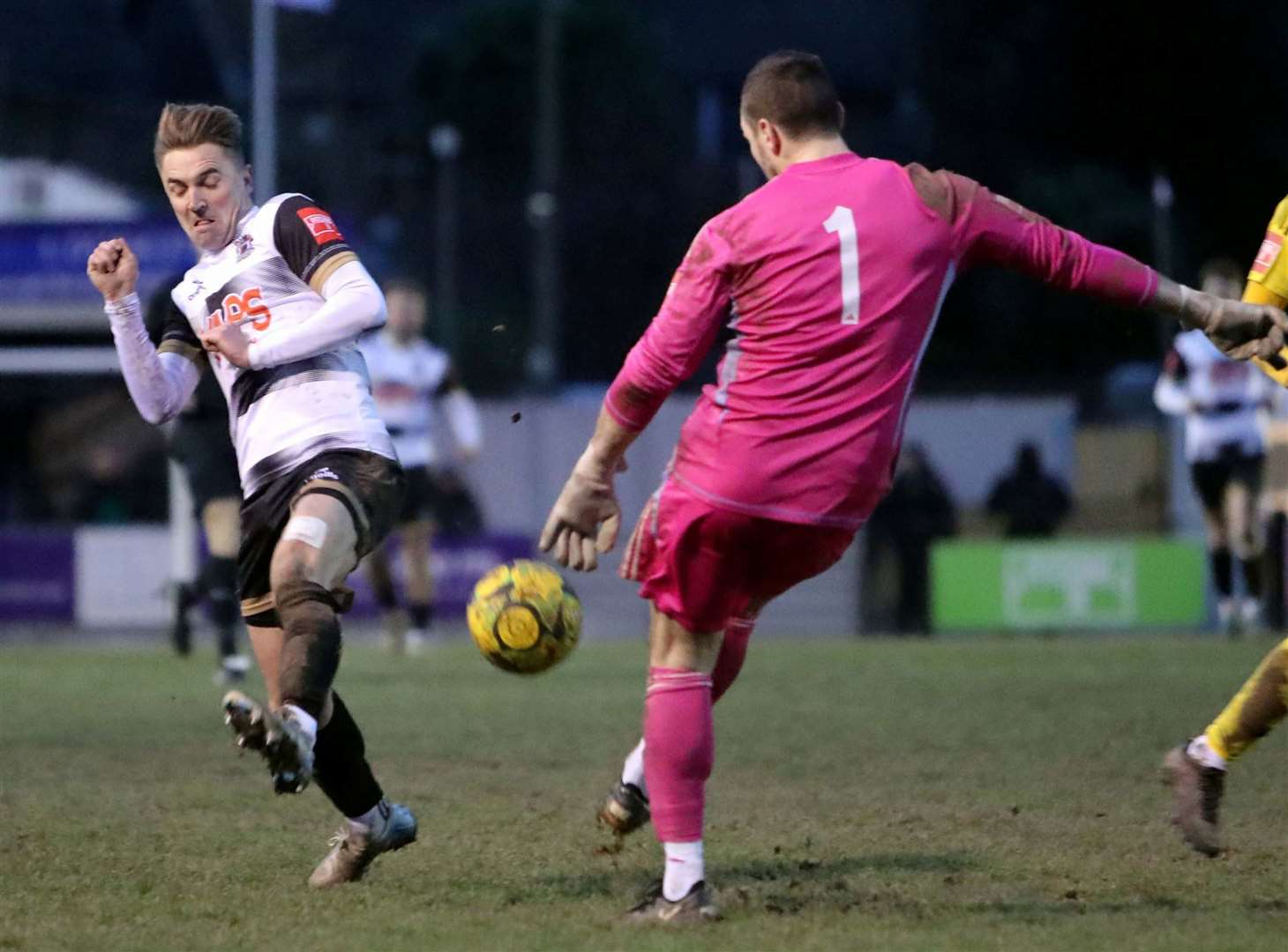 Deal's Tom Chapman puts the pressure on Burgess Hill keeper Slav Huk in the Hoops’ 5-3 Isthmian South East defeat on Saturday. Picture: Paul Willmott