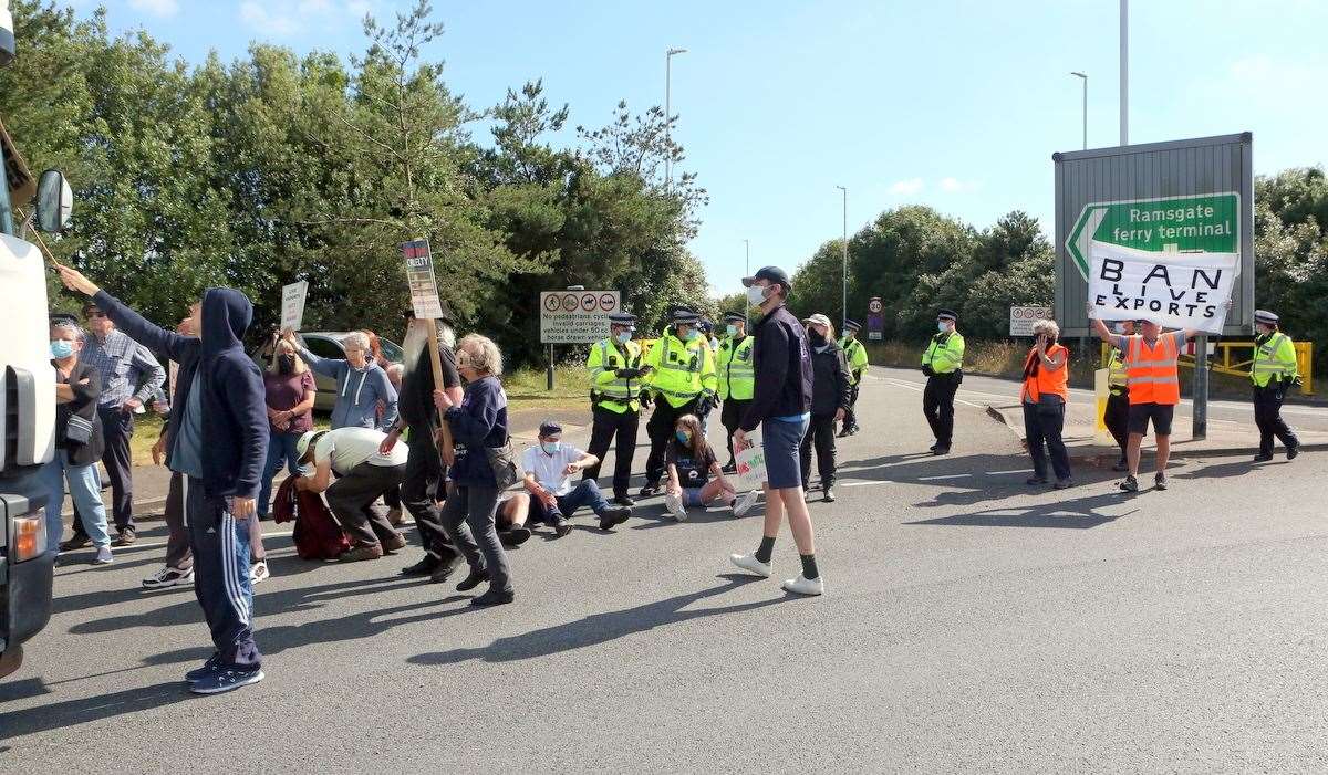 Protestors staged a sit-down protest in front of the vans when they were stopped. Photo: UKnip