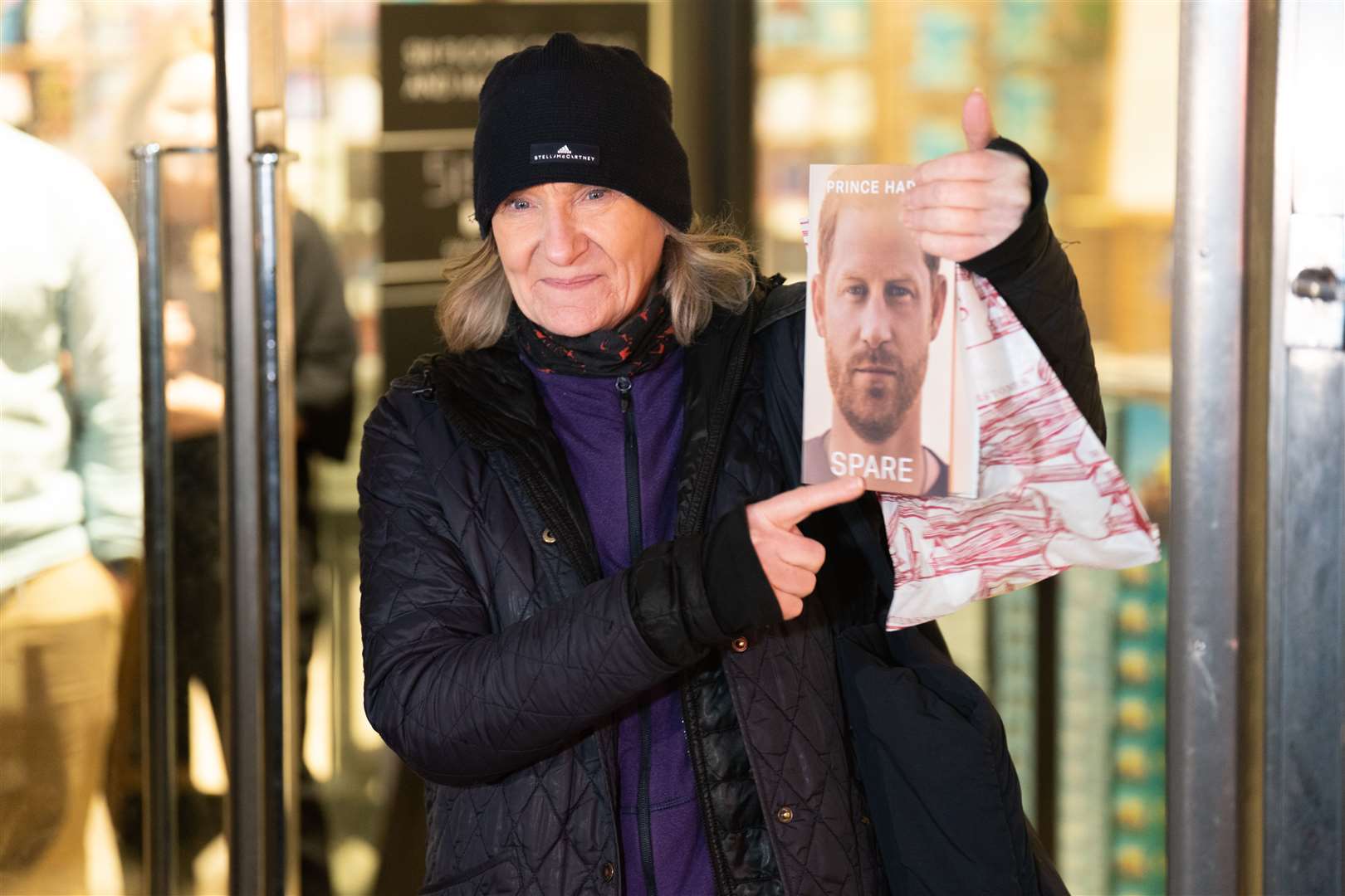 Caroline Lennon, the first customer to purchase a copy of Spare, leaves Waterstones Piccadilly (James Manning/PA)