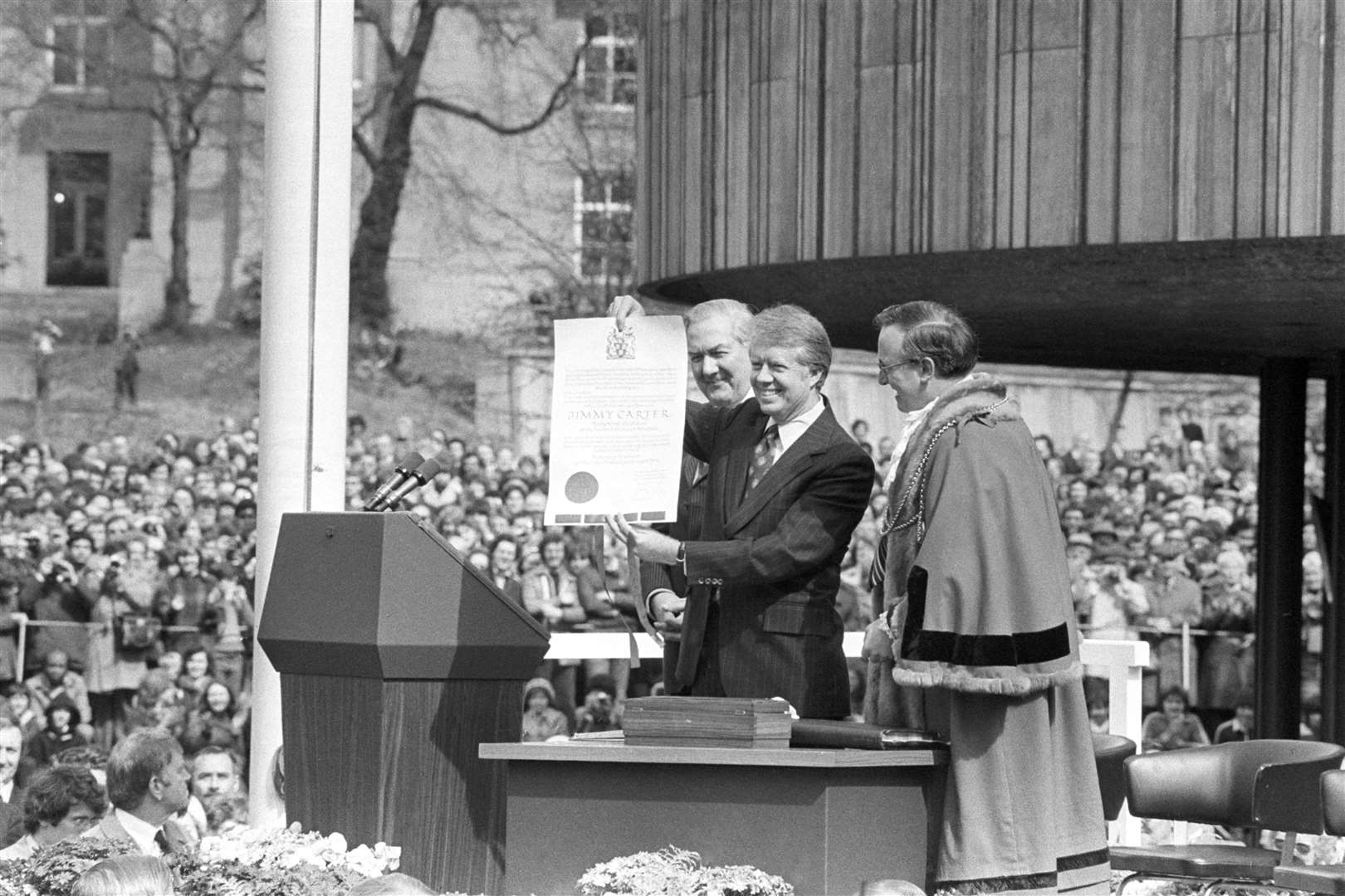 President Jimmy Carter holds up a scroll presented to him by the Lord Mayor of Newcastle Councillor Hugh White (Archive/PA)