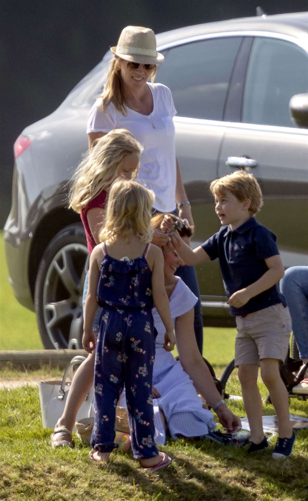 But it’s not all official photocalls for the young prince – here he played with his mother and Autumn Phillips and her children, Savannah and Isla, while the Duke of Cambridge played polo at Beaufort Polo Club (Steve Parsons/PA)