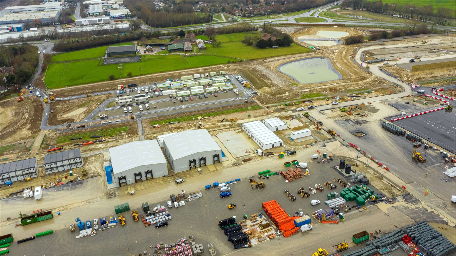 Some buildings have been erected on the Sevington facility; the entrance to the staff car park can be seen on the left, accessed off Church Road