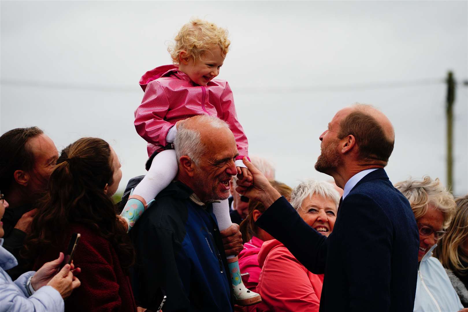 The Prince of Wales meets a young girl on a visit to Llanelli (Ben Birchall/PA)