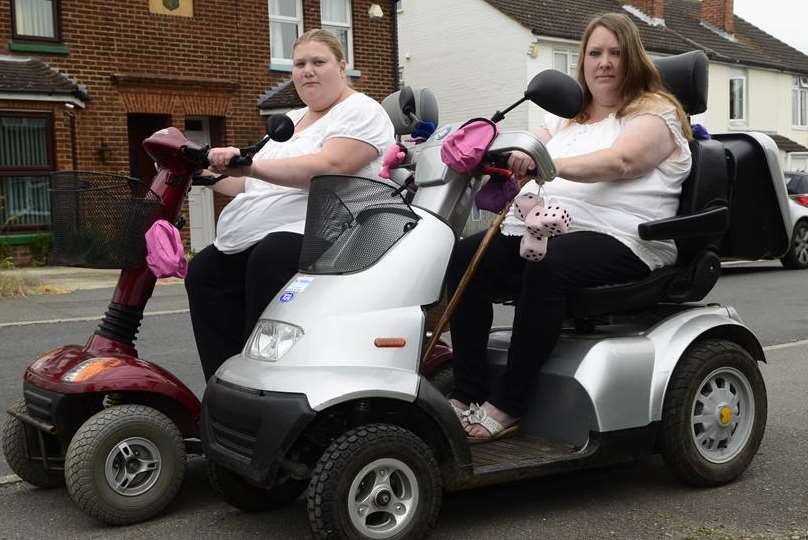 Young Emma Reed supports her disabled mother by also riding a mobility scooter