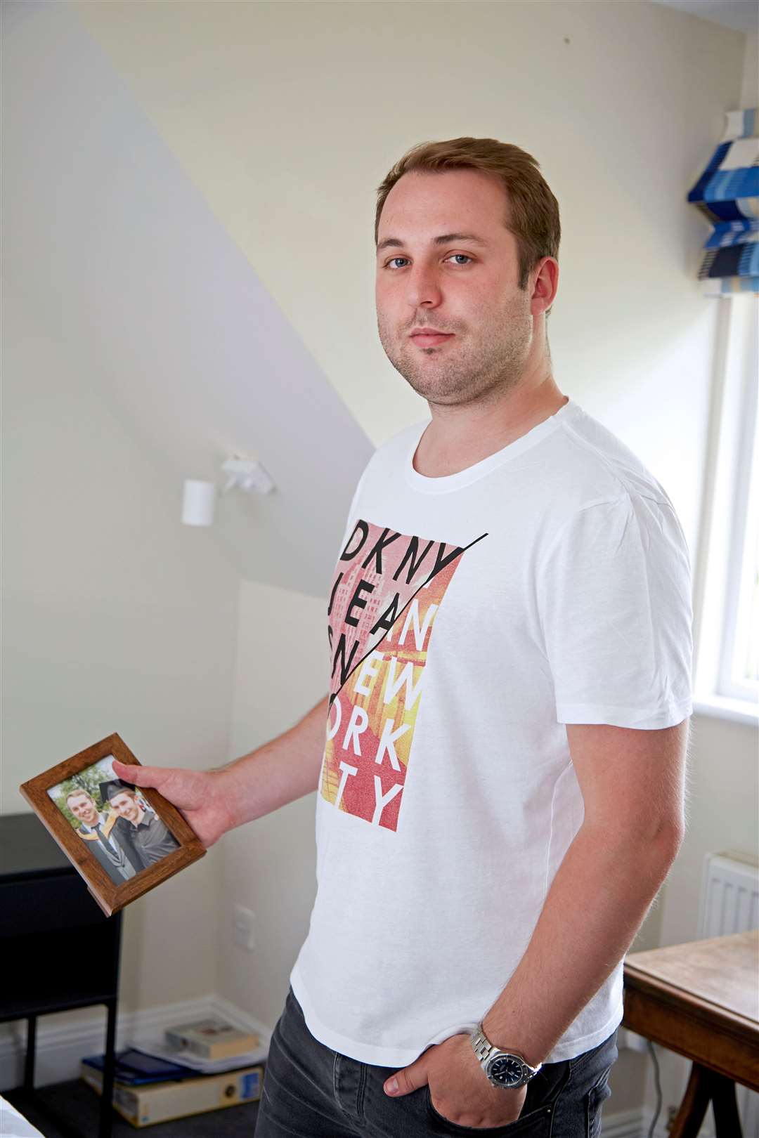 Nick Mason holds a photo of him and his brother Tim. Picture: Meningitis Now