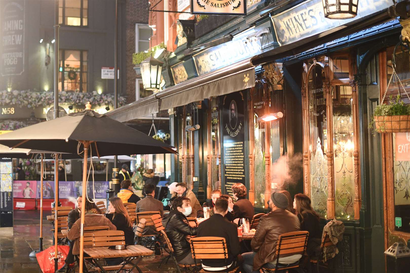 People sat outside a pub in the West End of London after the announcement that the capital and parts of Essex and Hertfordshire will face Tier 3 restrictions from Wednesday (Stefan Rousseau/PA)