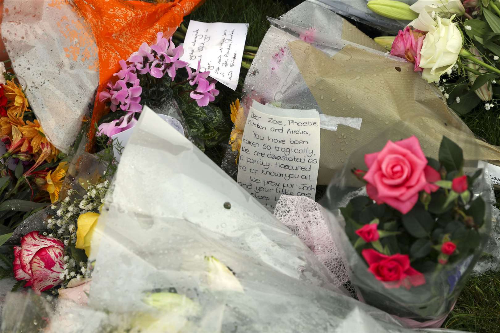 Floral tributes laid in front of a cross erected outside Chinnor Community Church (Steve Parsons/PA)