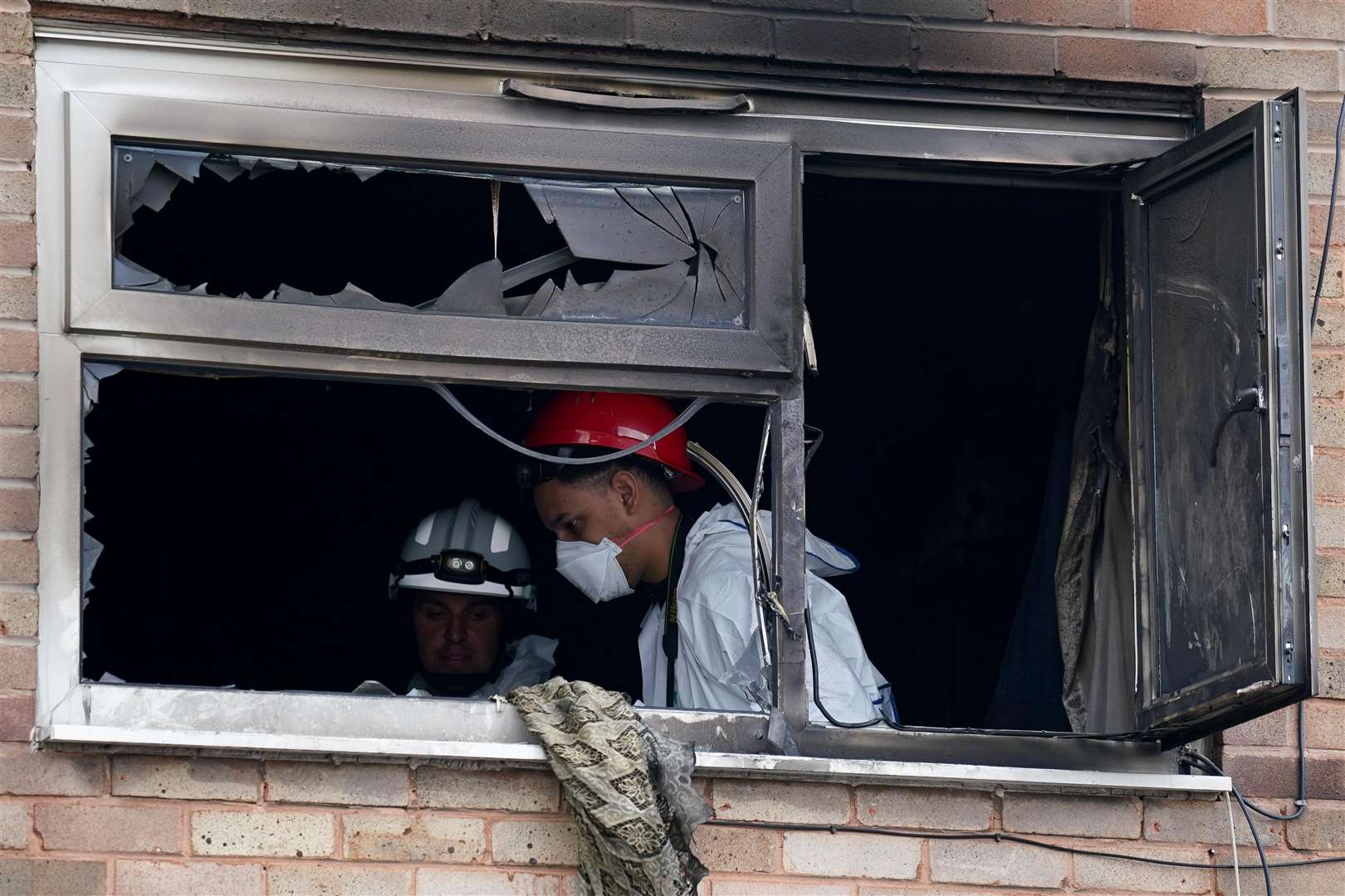 Fire investigation officers at the property (Jacob King/PA)