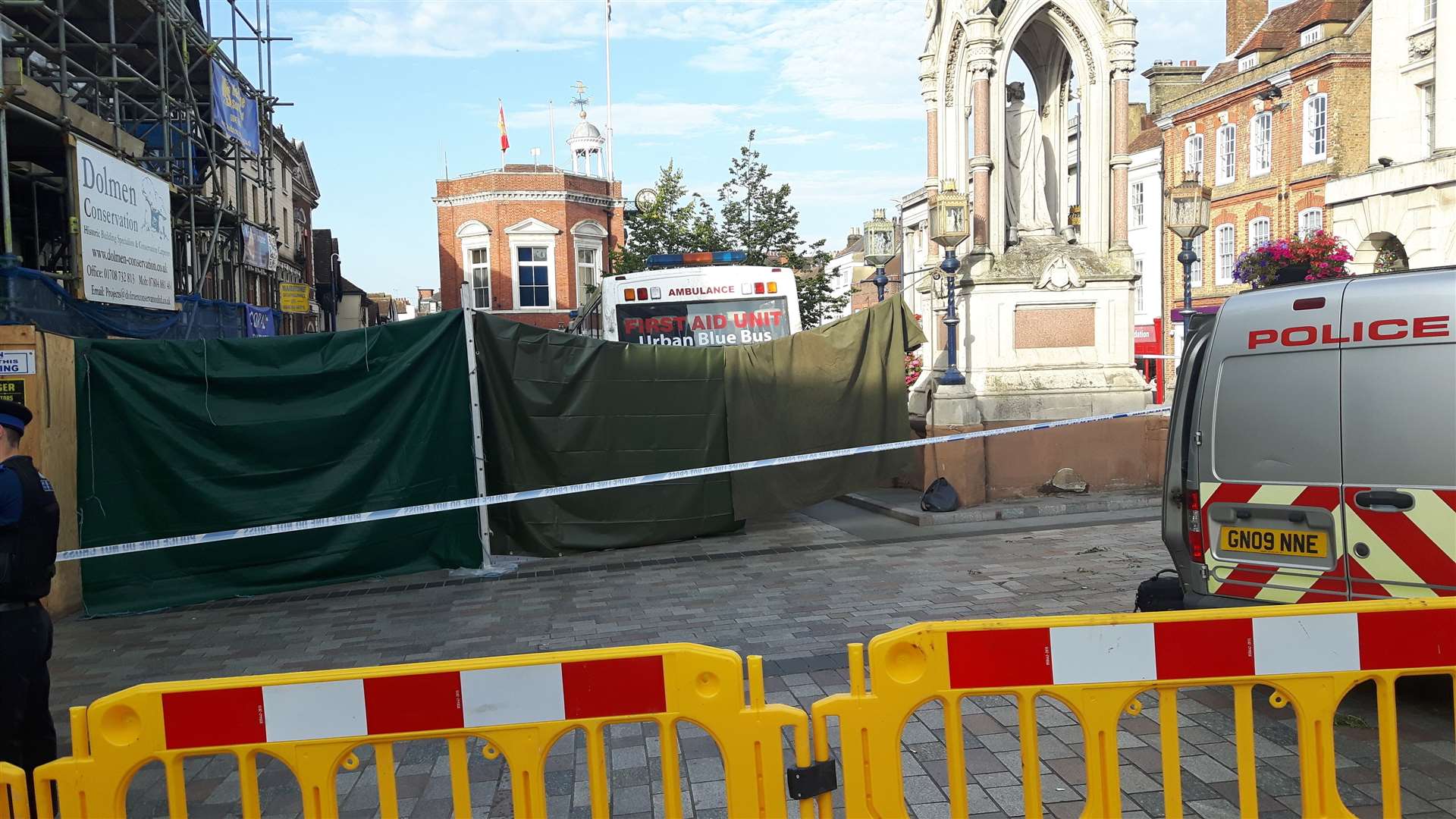 The Urban Blue Bus, just visible behind this tarpaulin, is the focus of police activity